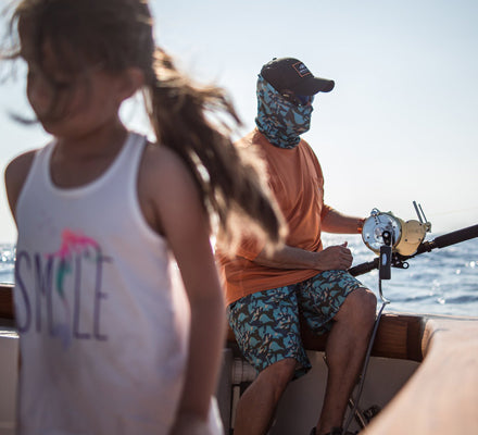 Ozzy fishing with his daughter looking at something